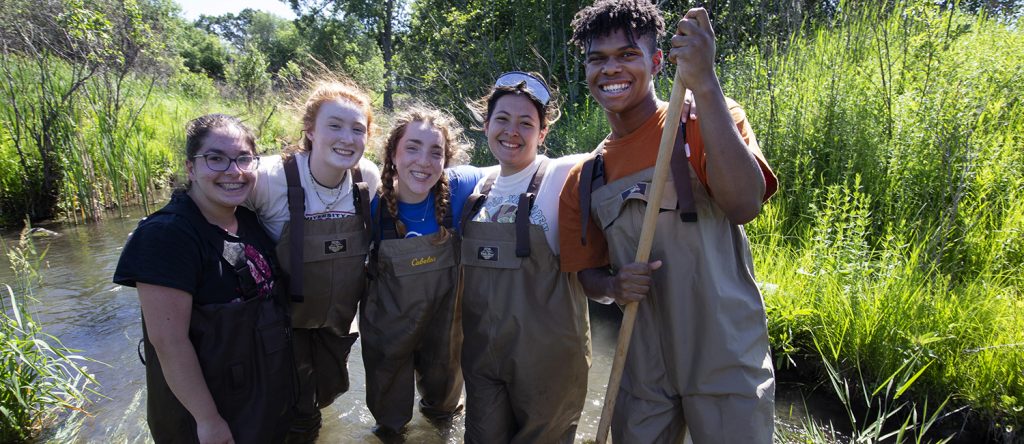 group of high school students in river