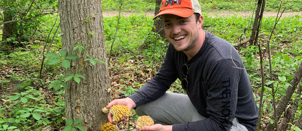 Male holding mushrooms